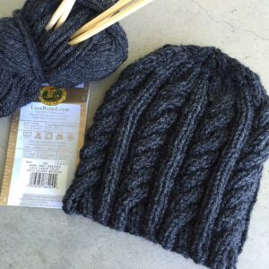 Worsted weight yarn and size 8 needles make a had for a child