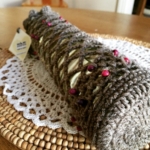 Crocheted wine bottle holder with beads.
