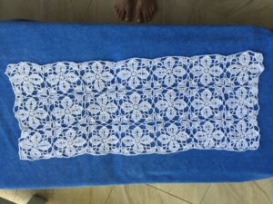 Summer poncho before sewing sides. 3 rows by 7 columns. 21 motifs.