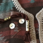 Buttons, DMC thread and embroidery needle for neck closure.