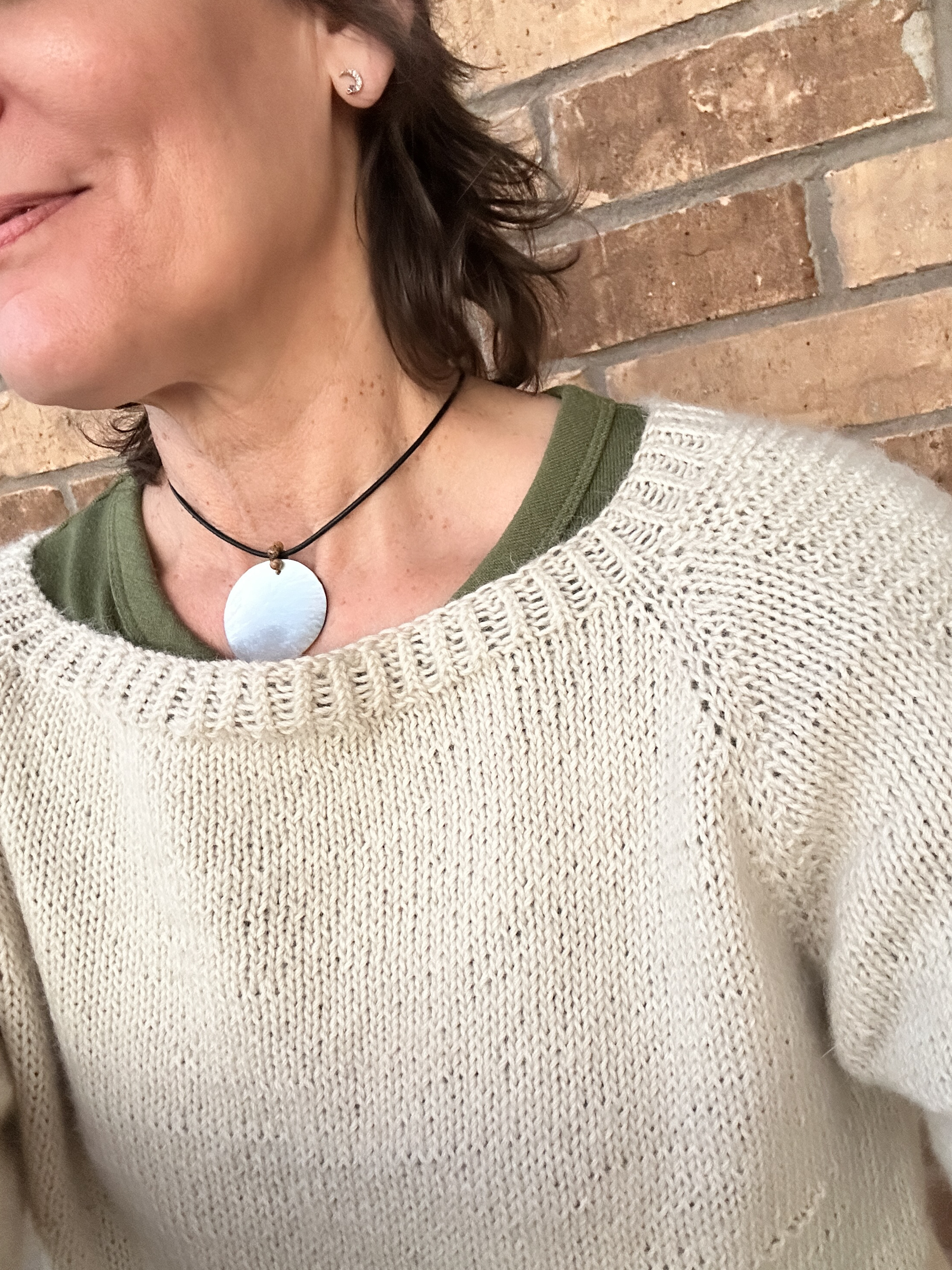 Showing the neckline of the Flax Sweater