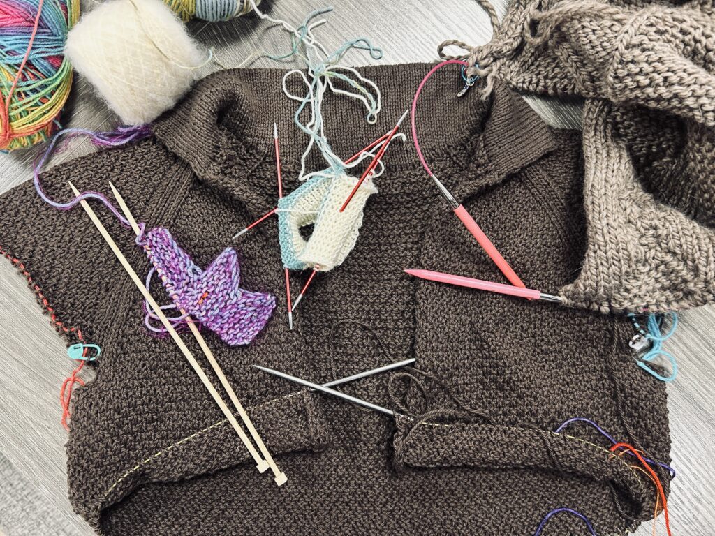 My Many WIPS on the table with lots of different needles